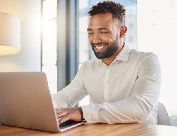 man smiling at laptop